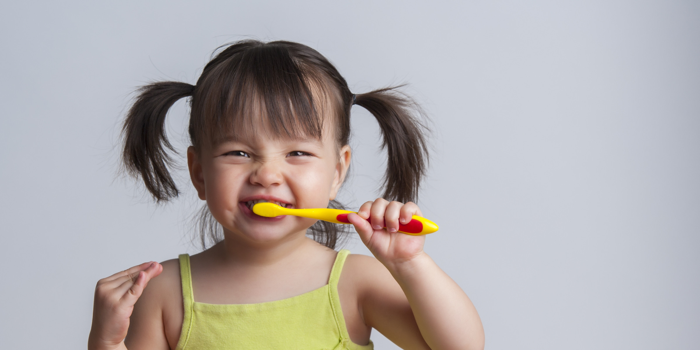 little girl brushing her teeth